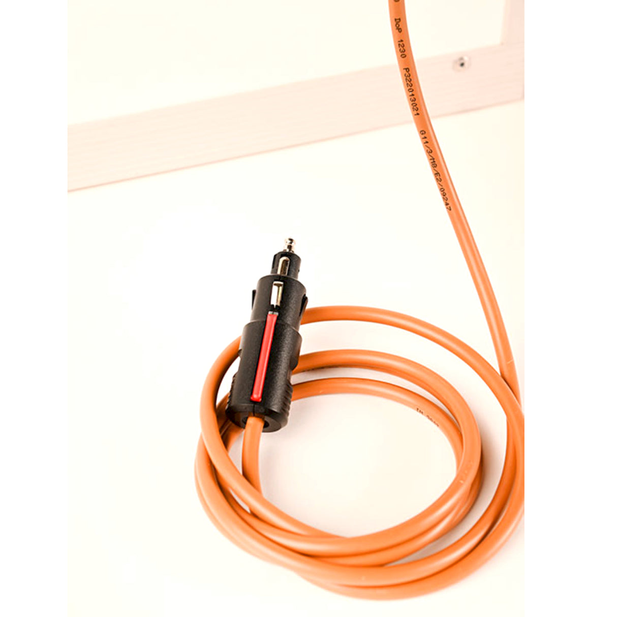 Royal Cells Portable Incubator Coiled orange extension cord with a black plug on a white background